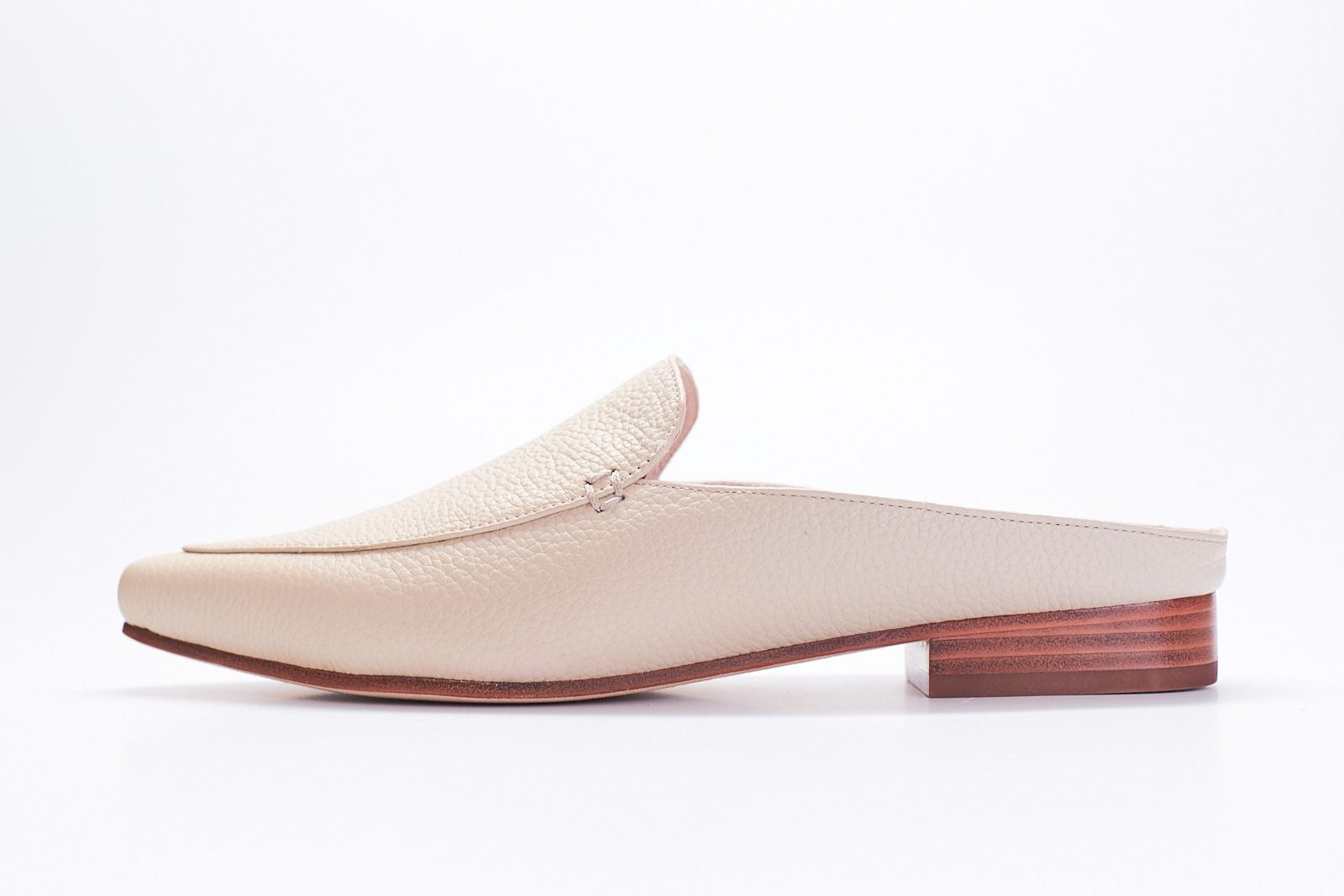 oyster colored tumbled leather mule slides with plain vamp and stacked brown heel.