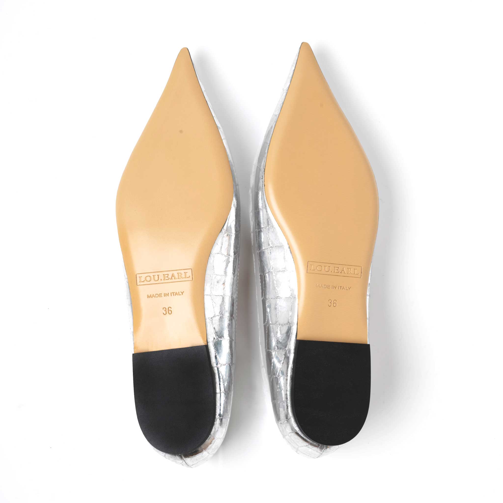 ultra pointed slip on flat shoes for women showing tan natural sole and black heel with logo stamped on outsole and "made in Italy"