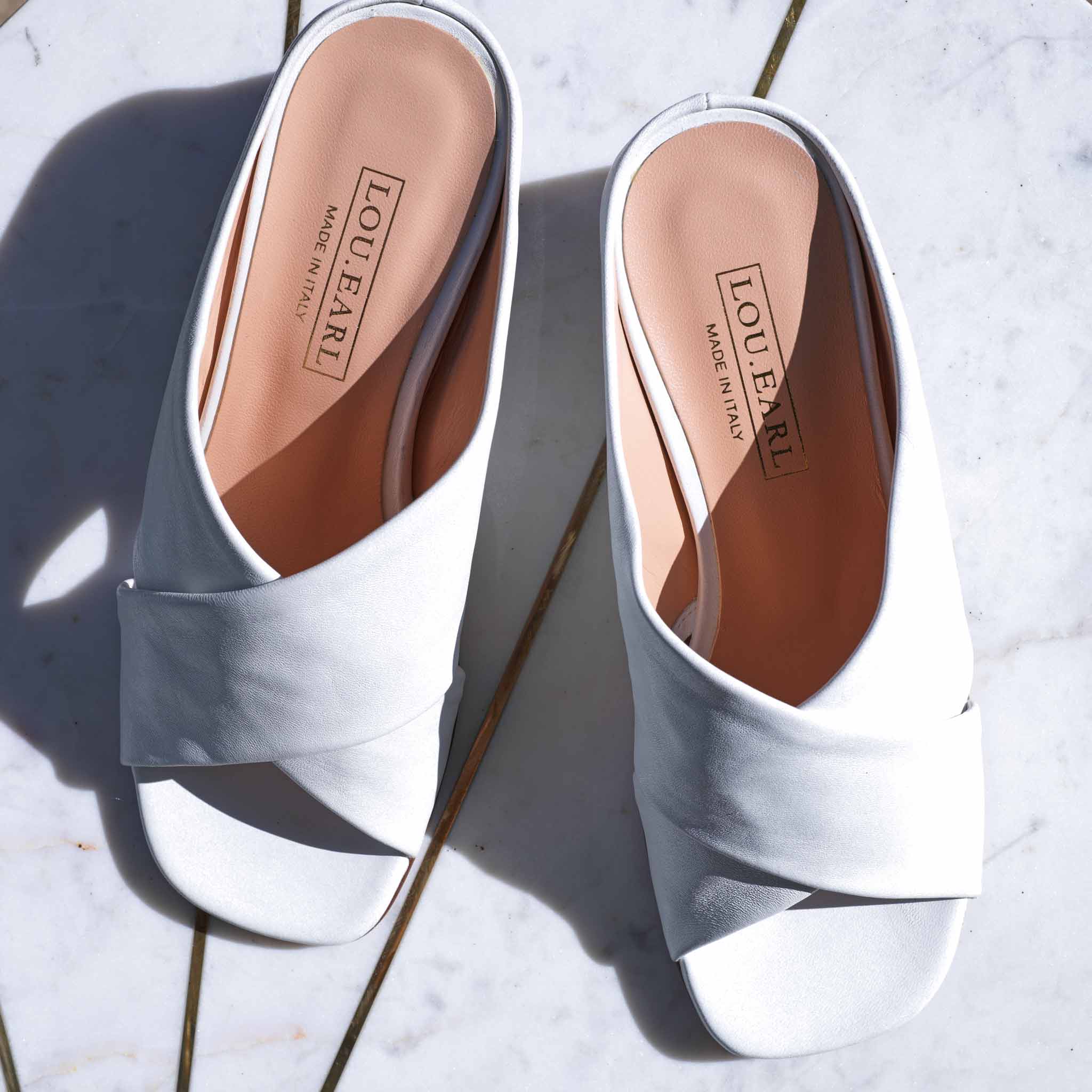 modern and classic white open back slide sandals in soft buttery italian leather with cushioned insole