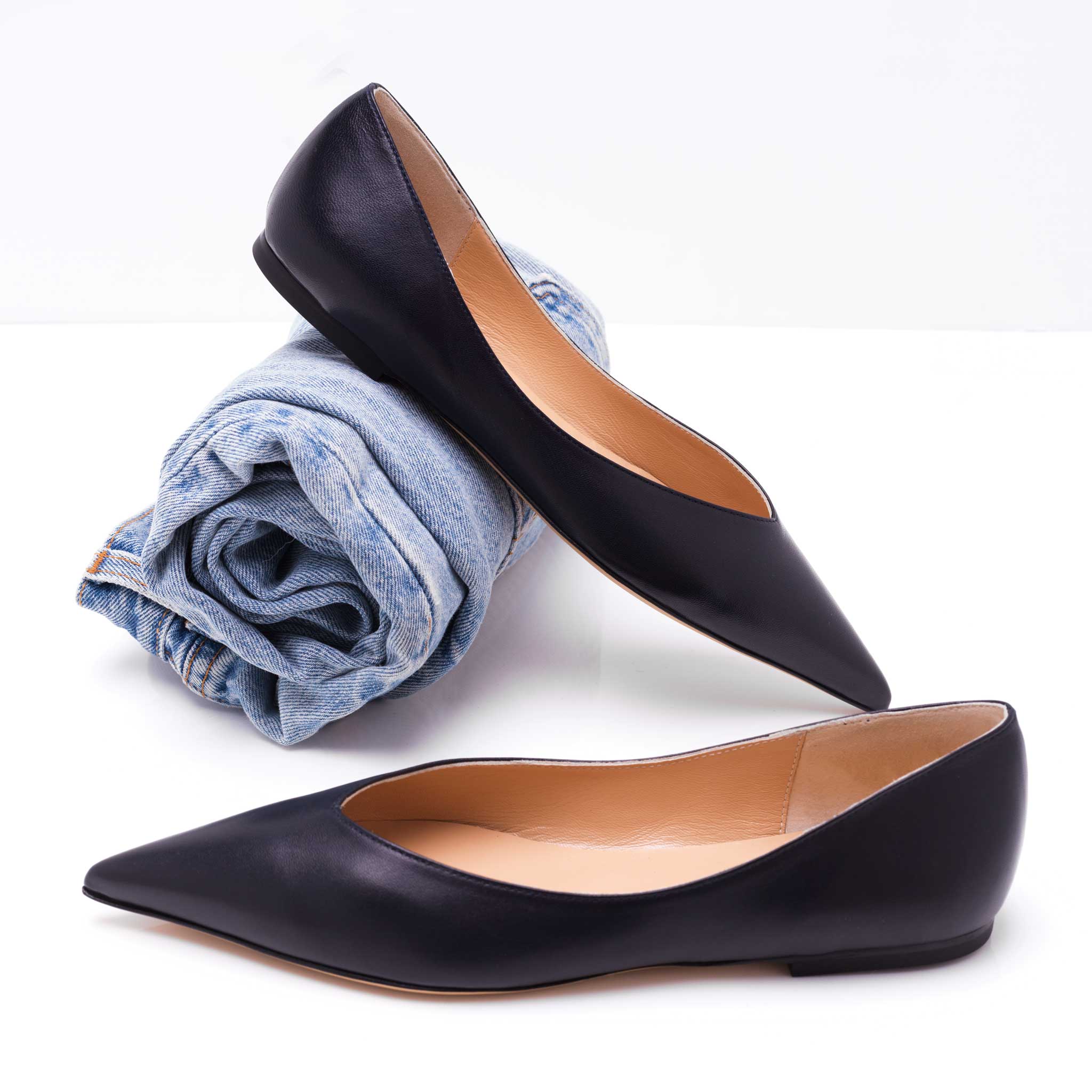 leather navy blue slip on flat shoes for women shown with vintage levis.